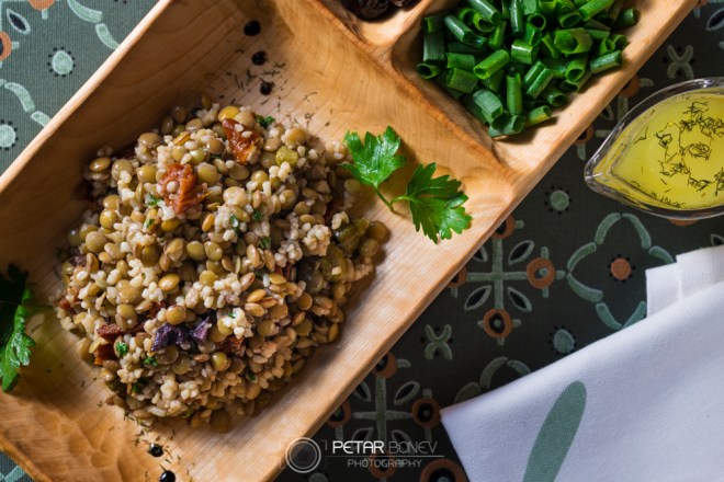 Traditional lentils salad with dried tomatoes, olives and couscous